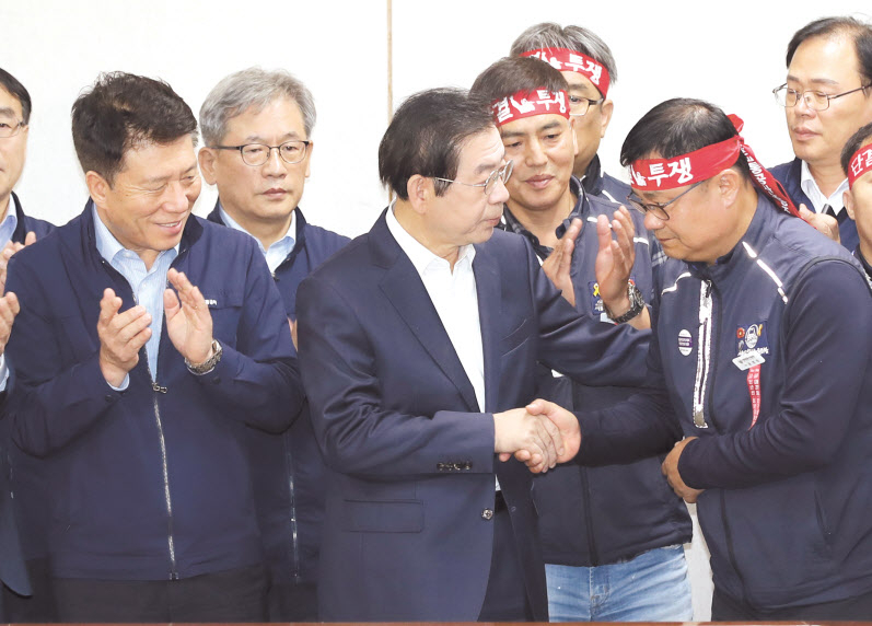 서울 지하철 노사 협상이 타결된 16일 오전 서울 성동구 서울교통공사 본사에서 박원순 서울시장과 윤병범 노조위원장이 악수하고 있다. [연합]