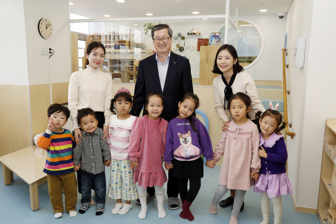 포스코에너지 직장어린이집 확장·이전 개원식에서 박기홍 포스코에너지 사장(사진 가운데), 교사와 어린이들이 함께 기념 촬영을 하고 있다.[포스코에너지 제공]