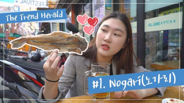 Euljiro Nogari Alley in Seoul packed with outdoor tables and customers drinking beer with dried pollack snacks under hanging flags