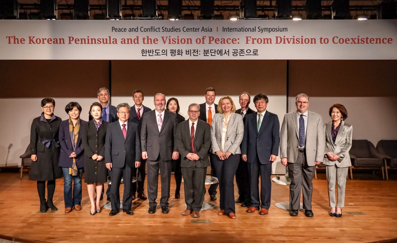 Participants pose for a photo at “The Korean Peninsula and the Vision of Peace: From Division to Coexistence,” an annual symposium hosted by George Mason University at its campus in Incheon, Wednesday. (George Mason University)