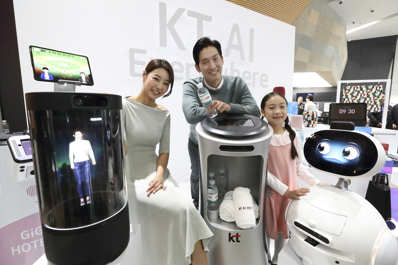 KT officials showcase its Giga Genie AI-powered devices during a press event in Seoul. KT