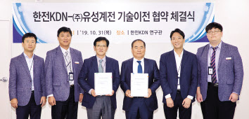 정재훈(왼쪽에서 세번째) 한전KDN 전력ICT개발원장과 이진락(오른에서 세번째) 유성계전 사장이 기술이전 협약을 체결한 뒤 양측 관계자들과 기념촬영을 하고 있다. [한전KDN 제공]