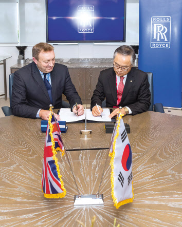 지난 5일(현지 시간) 영국 더비에 위치한 롤스로이스 사업장에서 신현우 한화에어로스페이스 사장(오른쪽)과 앤디 그리즐리 롤스로이스 터빈사업부장이 항공기 부품 공급 계약을 계약을 체결하고 있다.