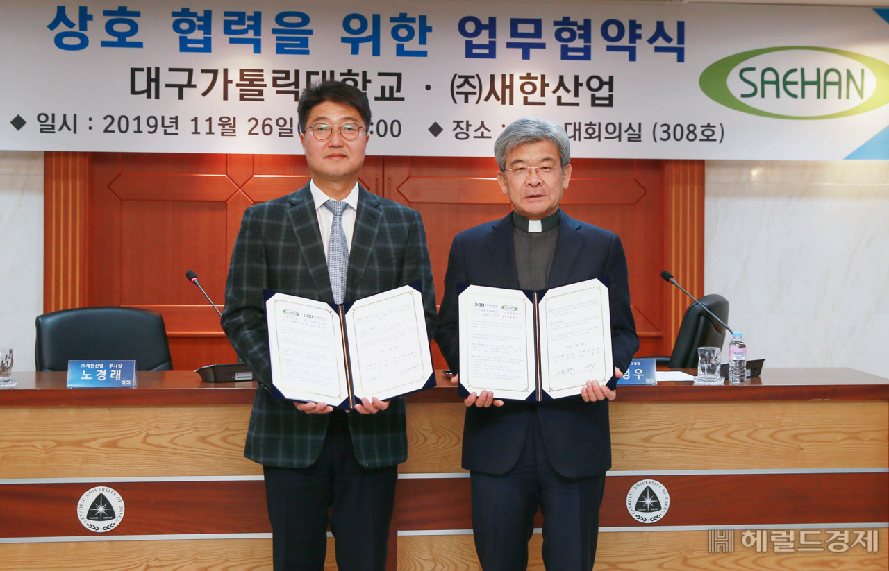 26일 업무협약을 체결한 김정우 대구가톨릭대 총장(오른쪽)과 노경래 ㈜새한산업 부사장.[대구가톨릭대 제공]