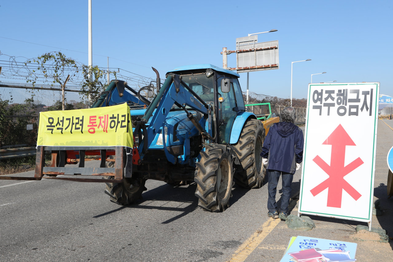 A villager walks near the quarantine sign in Paju, South Korea, near the border with North Koreaafter, where an outbreak of African swine fever has occured in September. Yonhap
