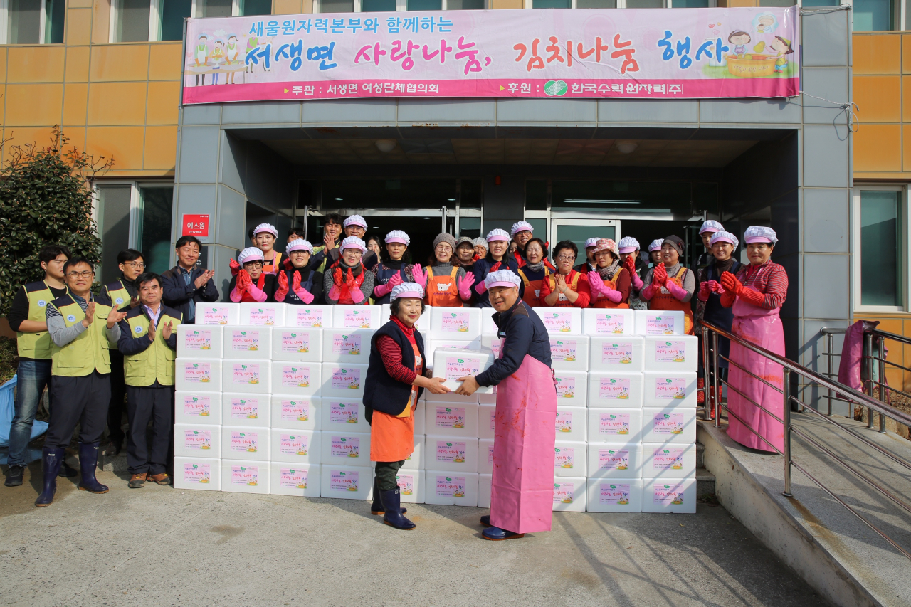 한국수력원자력 새울원자력본부가 김장 김치 1200포기를 담그는 ‘사랑 나눔, 김치 나눔’ 봉사 활동을 한 뒤 기념촬영을 하고 있다. [한국수력원자력 새울원자력본부 제공]