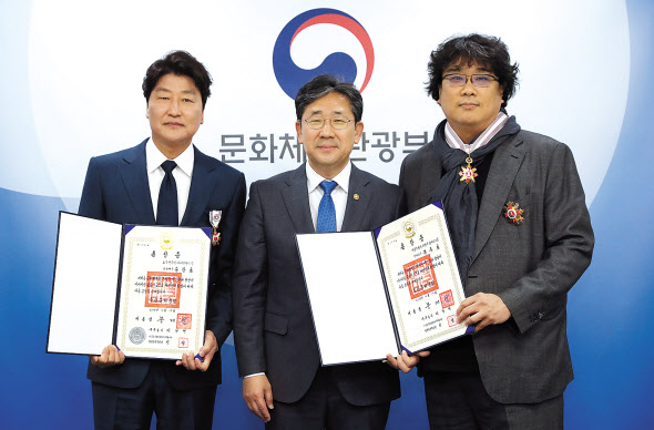 박양우(가운데) 문화체육관광부 장관이 지난 19일 국립국단에서 칸 국제영화제에서 회우수 작품상을 수상한 영화감독 봉준호(오른쪽)와 영화배우 송강호(왼쪽)에게 각각 은관문화훈장과 옥관문화훈장을 수여한 뒤 기념촬영을 하고 있다. [문체부 제공]