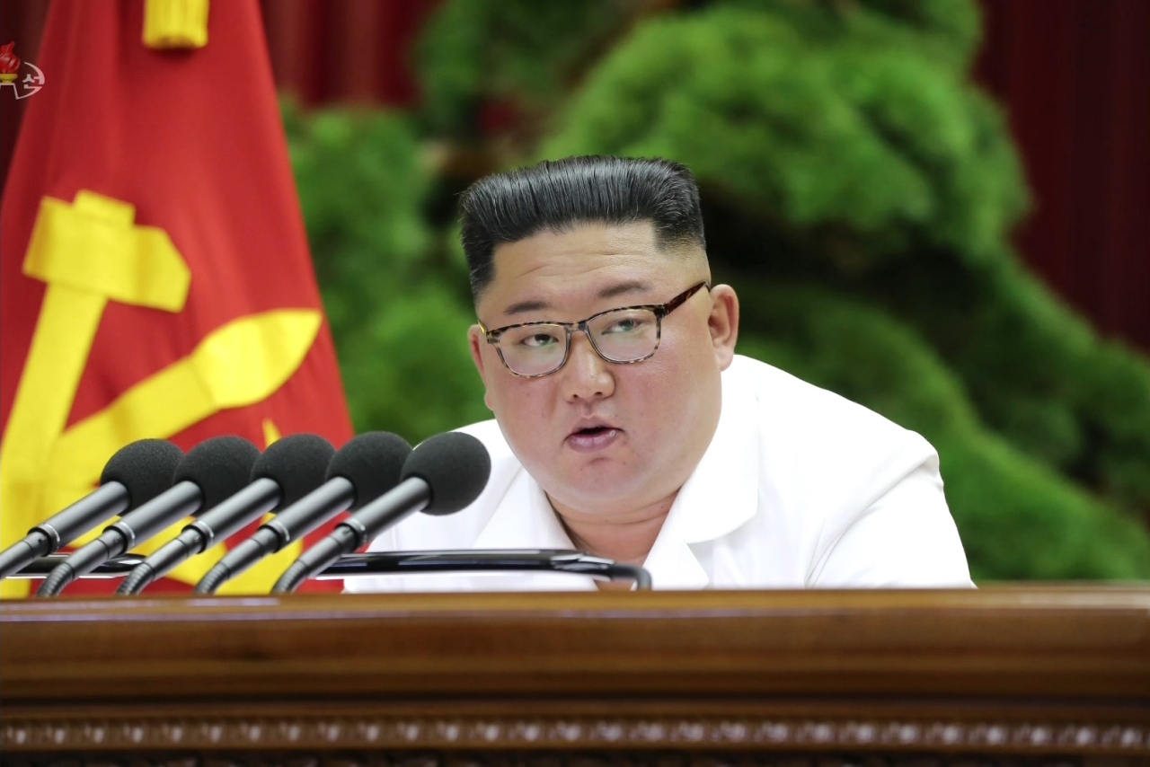 North Korean leader Kim Jong-un is seen speaking at the party's plenary meeting on Sunday in an image released by the Korean Central News Agency. Yonhap