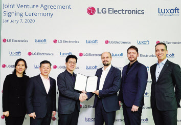 LG전자와 글로벌 소프트웨어 기업 룩소프트(Luxoft)가 7일(현지시간) 미국 라스베이거스에서 조인트벤처 설립을 위한 협약식을 맺었다. LG전자 CTO 박일평 사장(왼쪽에서 세번째)과 룩소프트 미하일 비코브(Mikhail Bykov, 왼쪽에서 네번째) 오토모티브 솔루션즈 부사장이 협약을 맺고 악수하고 있다. [LG전자 제공]