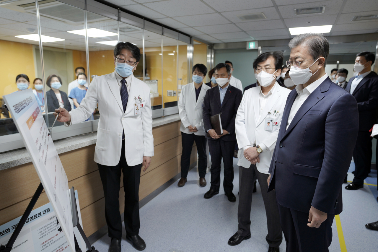 문재인 대통령이 28일 오전 신종 코로나바이러스 감염증 대응 의료기관인 서울 중구 국립중앙의료원에서 고임석 대응TF 팀장의 설명을 듣고 있다. [연합]