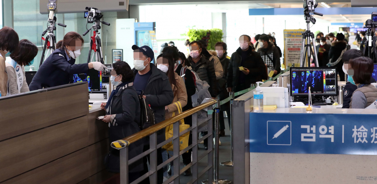우한 폐렴 공포가 확산 일로인 지난 28일 인천공항 제1터미널 입국장에서 중국발 항공기 탑승객 등이 발열검사를 받기 위해 줄을 서 있다. [연합]