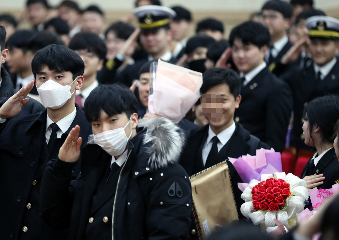 지난달 29일 부산 영도구 한국해양대학교에서 열린 해사대학 2019학년도 전기 학위수여식에서 신종 코로나바이러스 감염증 우려에 마스크를 쓴 졸업생이 국기에 대한 경례를 하고있다. [연합뉴스 제공]