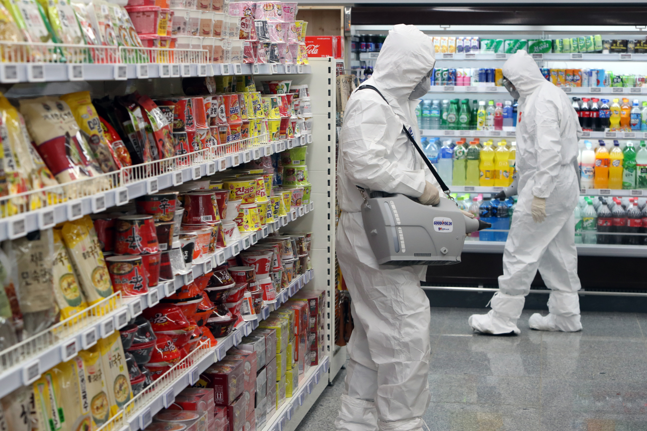 Quarantine officials disinfect a supermarket visited by 22nd patient in Naju, South Jeolla Province on Thursday. Yonhap