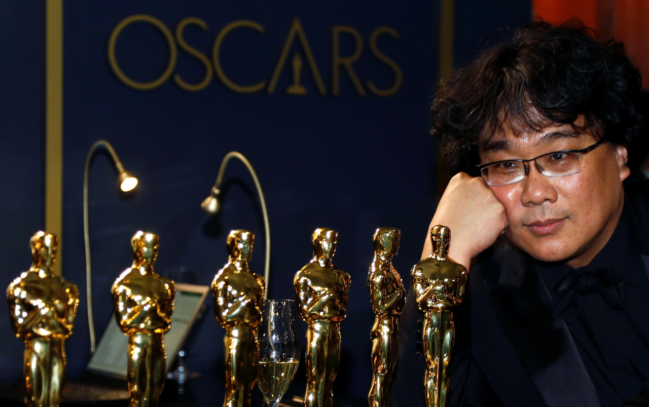 Director Bong Joon-ho poses with four Academy Awards for Parasite at the Governors Ball after the 92nd Oscars in Los Angeles
