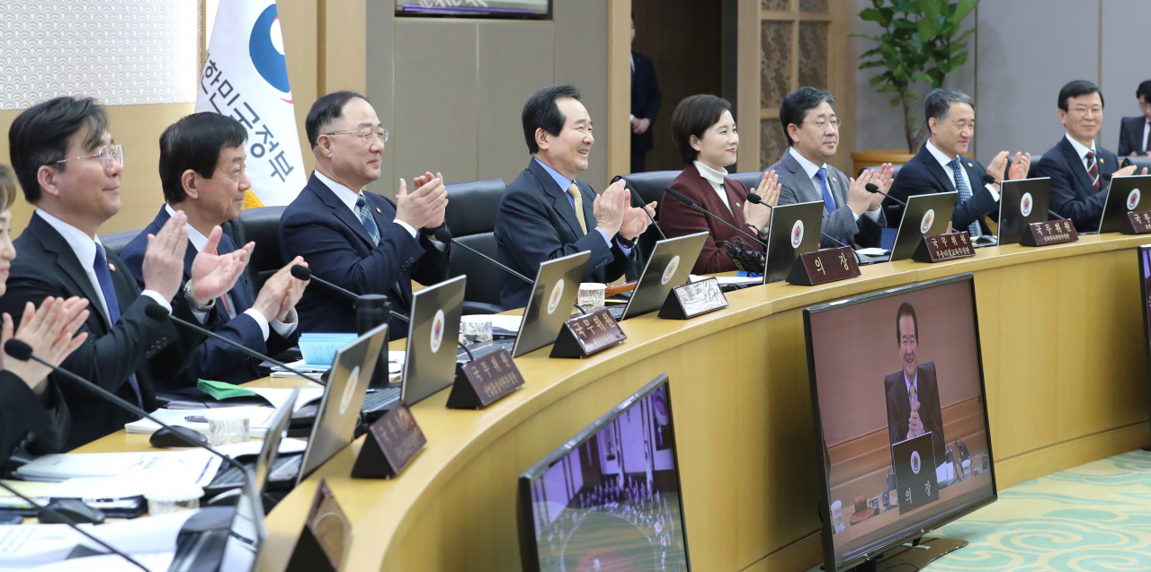 정세균 국무총리 등 국무위원들이 11일 오전 세종시 정부세종청사에서 열린 국무회의에서 영화 '기생충' 팀의 아카데미 시상식 4관왕 소식에 박수를 치며 축하하고 있다. ［연합］