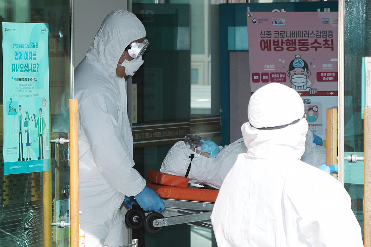 신종 코로나바이러스 감염증(코로나19) 두 번째 사망자가 발생한 21일 오후 경북 청도대남병원에 입원 중인 확진 환자가 부산대병원으로 이송되고 있다. [연합뉴스]