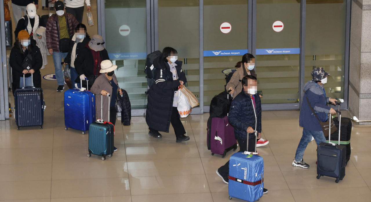 A group of Korean tourists, flown back home from Israel on a chartered flight arranged by the Israeli government, are seen at the Incheon Airport, west of Seoul, Tuesday morning. (Yonhap)