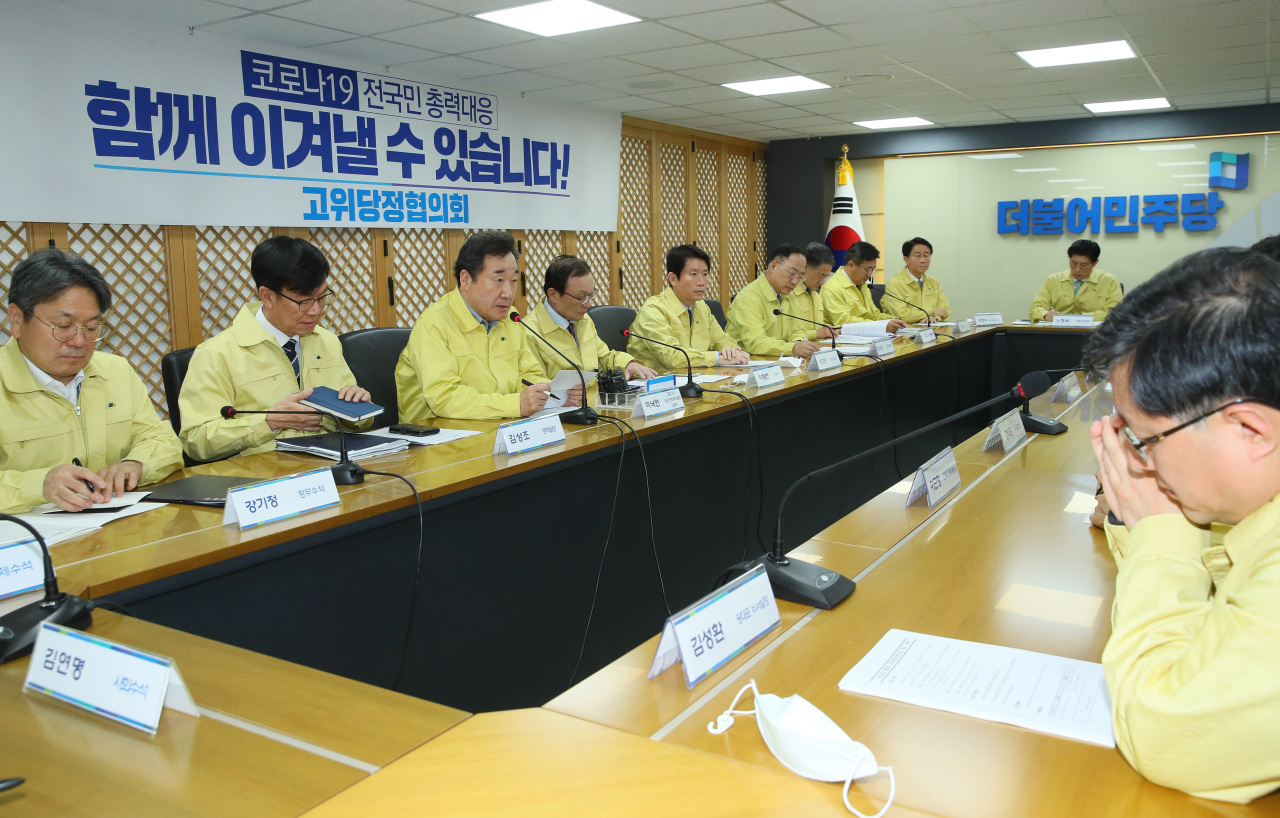 Officials from the presidential office, government and ruling Democratic Party hold a meeting in Seoul on Tuesday. Yonhap