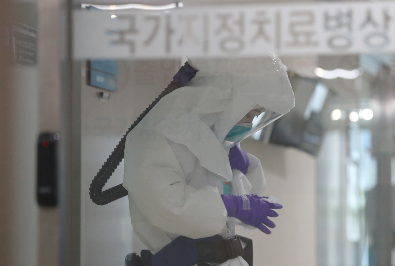 사진은 25일 오전 신종 코로나바이러스 감염증(코로나19) 환자가 치료를 받는 울산대병원 국가지정치료병상(음압병상)에서 의료진이 방호복을 착용하고 있는 모습. [연합]