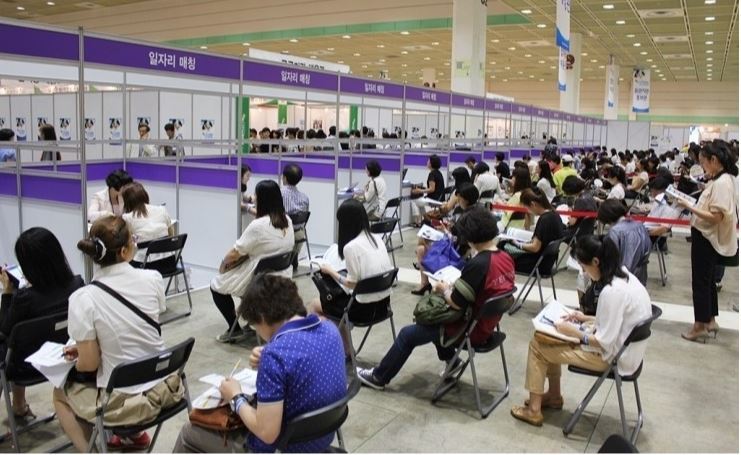 Applicants for temporary jobs, offered by the public sector, sit in rows during a job fair in Seoul. (Ministry of Employment and Labor