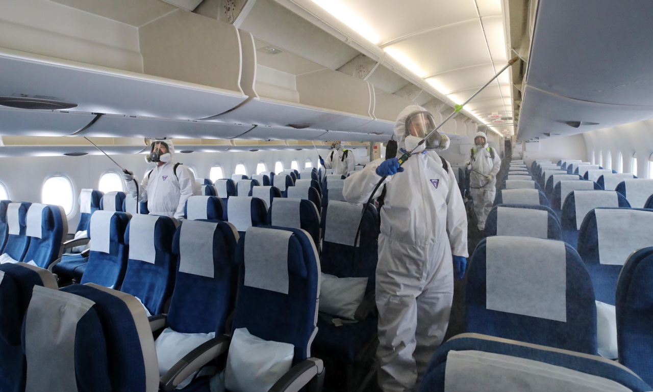 A Korean Air jet is disinfected on March. 4. Yonhap