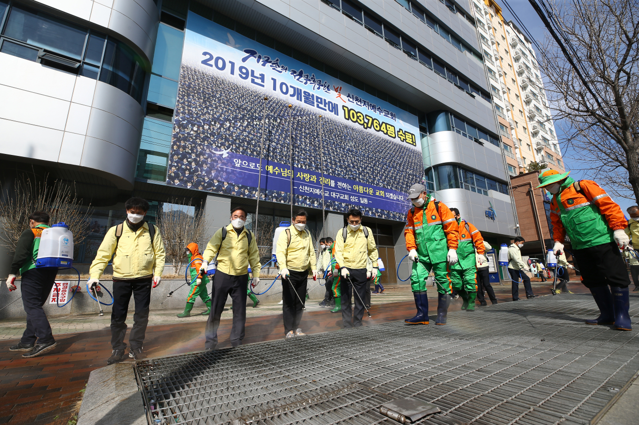6일 오후 대구시 남구 대명동 신천지 대구교회 앞에서 조재구 남구청장 등 남구청 관계자들이 신종 코로나바이러스 감염증(코로나19) 확산 방지 방역을 하고 있다. [연합]