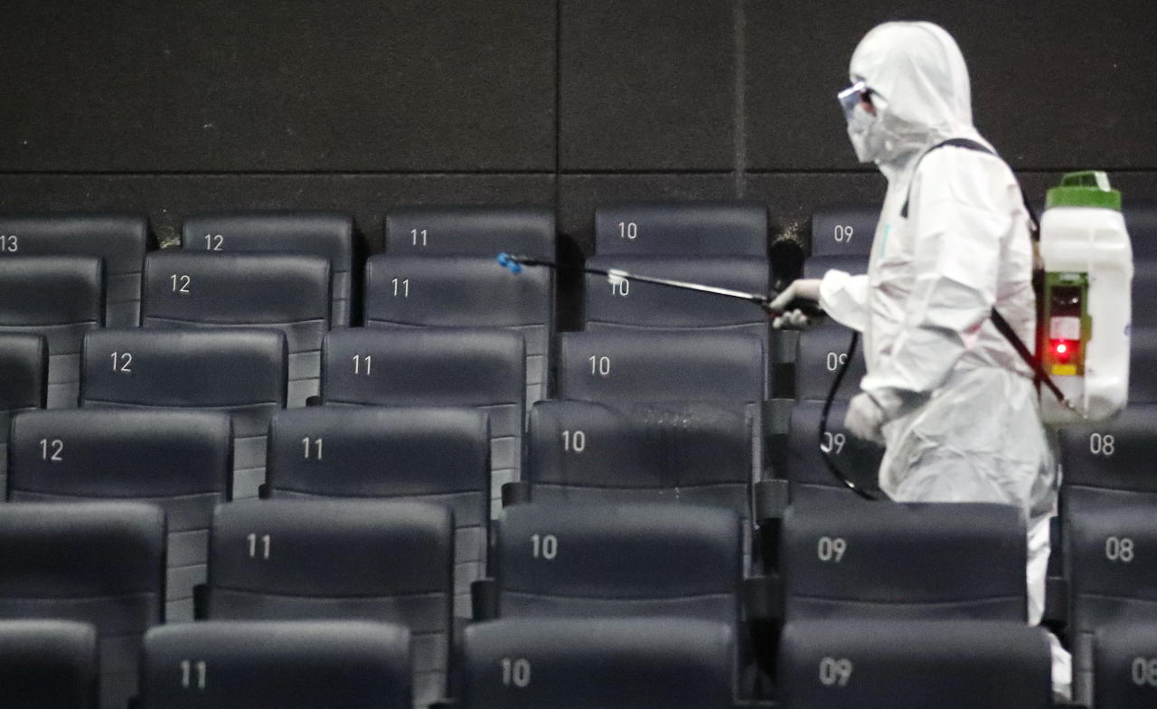 A quarantine official disinfects a cinema located in Gwangjin-gu, Seoul, on Feb. 26. (Yonhap)