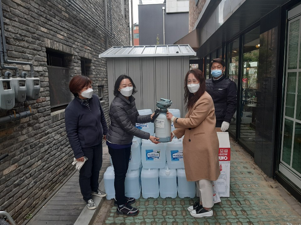 구청 직원이 광교 숲속마을 상인회에 휴대용 소독기와 약품을 빌려주고 있다. [용인시 제공]