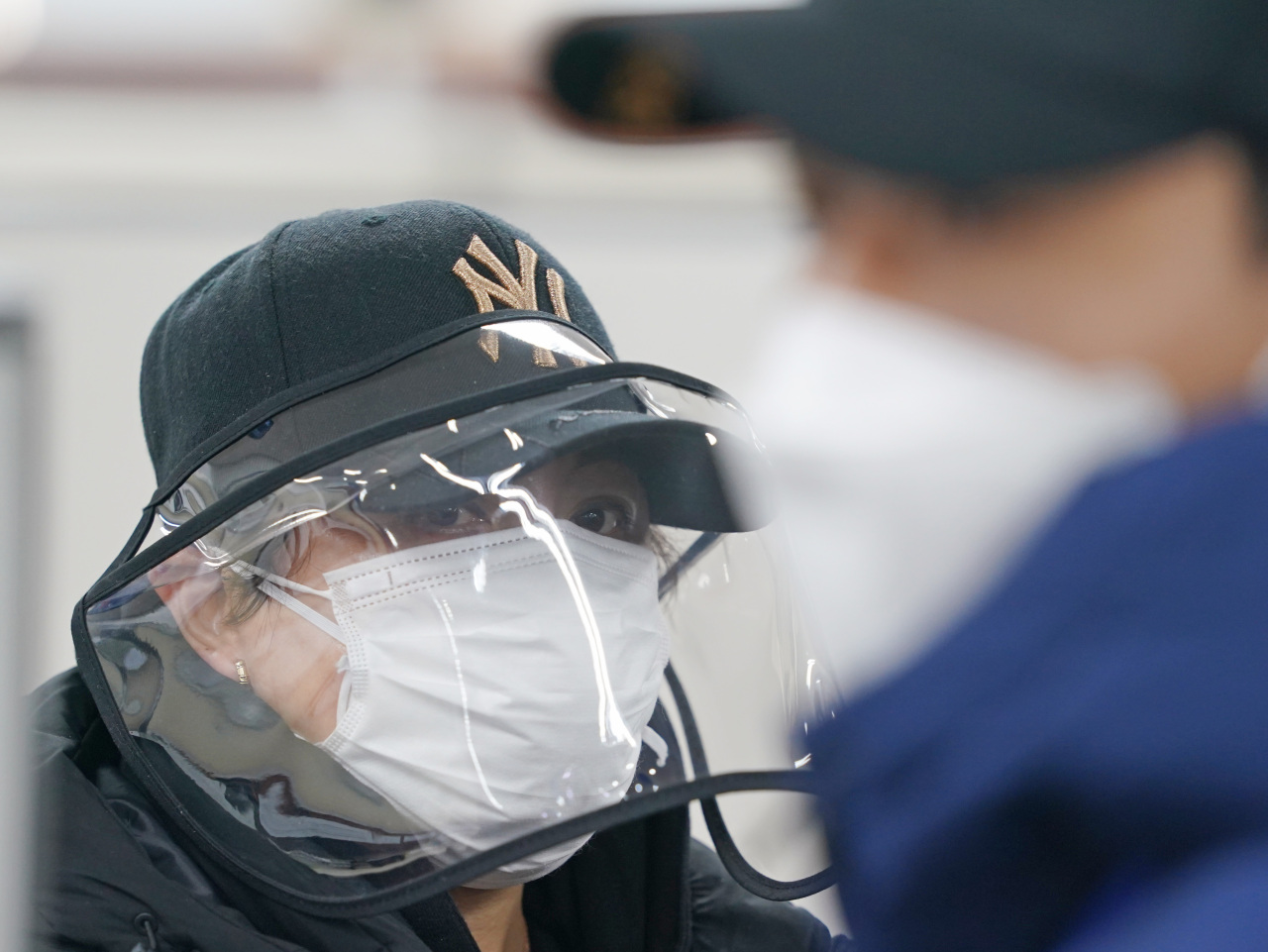 An illegal immigrant visits an immigration office in Seoul to voluntarily report herself on March 6. (Yonhap)