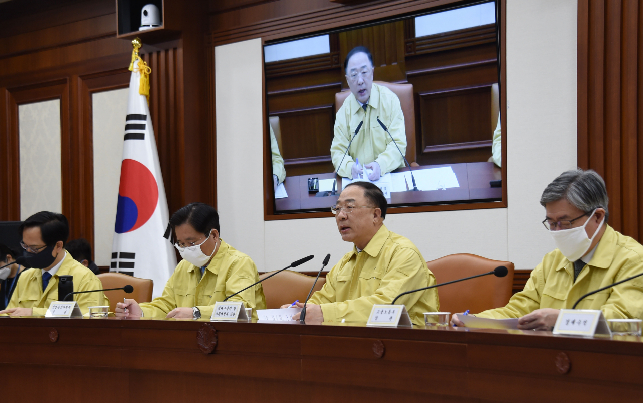 정부의 긴급 재난생계지원금은 위기에 처한 민생에 숨통을 터주는 사회안전망 강화로서 의미가 크지만, 침체 일로를 겪고 있는 경기를 부양하는 데에는 한계가 많다는 분석이다. 홍남기 부총리 겸 기획재정부 장관이 지난 25일 정부서울청사에서 ‘제12차 코로나19 대응 경제관계장관회의 겸 제2차 위기관리대책회의’를 주재하고 있다. [기획재정부 제공]