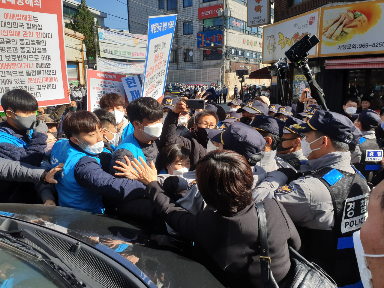 신종 코로나바이러스 감염증(코로나19) 확산 억제를 위한 '강화된 사회적 거리두기'가 시행되고 있지만 29일에도 서울 일부 교회는 현장 예배를 강행하고 있다. 사진은 29일 현장예배를 열려는 사랑제일교회 관계자들과 경찰이 충돌하는 모습. 연합뉴스