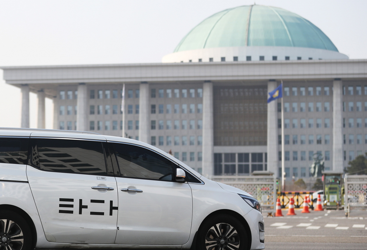 지난 6일 국회를 통과한 여객자동차 운수사업법 개정안(일명 타다 금지법)이 국무회의에서 의결돼, 내년 상반기 중으로 시행될 예정이다. 서울 여의도 국회 앞을 지나는 타다 차량 모습. [연합]