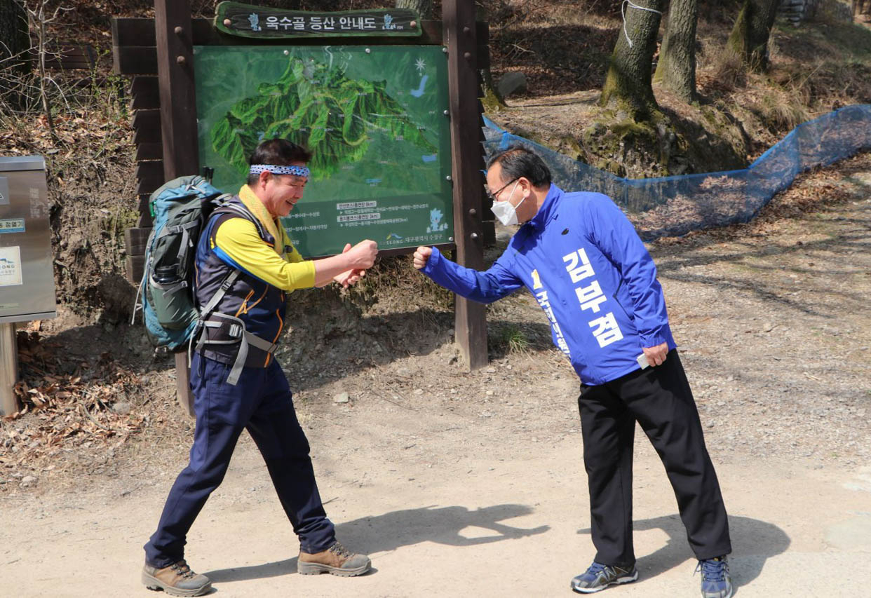 대구 최대 격전지로 떠오른 수성갑에서 5선에 도전하는 김부겸 더불어민주당 후보가 29일 대구 수성구 욱수골에서 아침 운동 나온 시민과 주먹인사를 나누고 있다. [연합]
