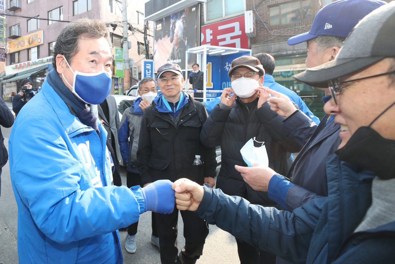 서울 종로 이낙연 더불어민주당 후보가 4일 오전 서울 종로구 명륜동의 한 골목에서 주민들과 주먹을 부딪치며 인사를 하고 있다. [연합]