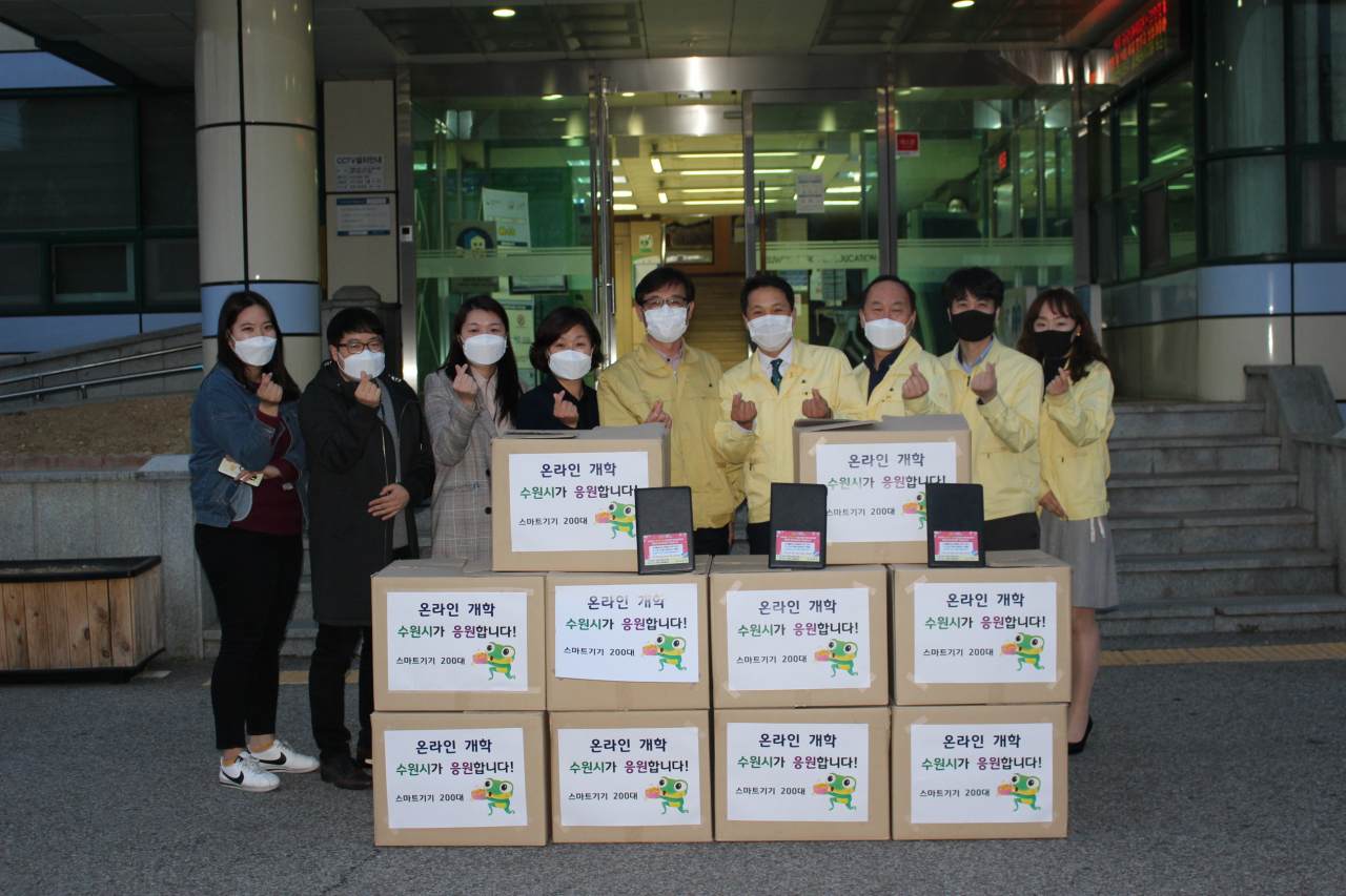 장수석 수원시 정보통신과장(왼쪽 5번째), 김인종 수원교육지원청 경영지원과장(오른쪽 5번째)과 직원들이 태블릿PC 전달 후 함께하고 있다. [수원시 제공]