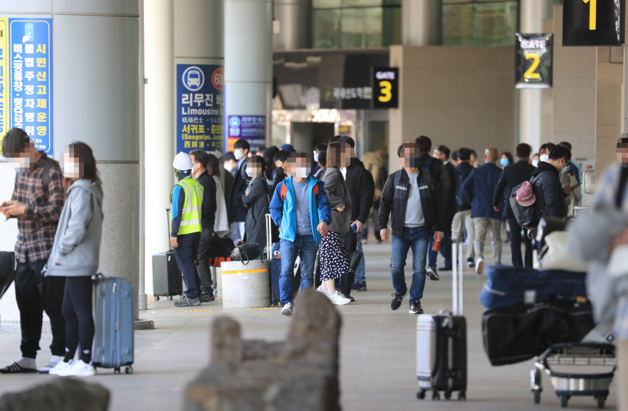 People arrive at the Jeju International Airport on Wednesday. Yonhap