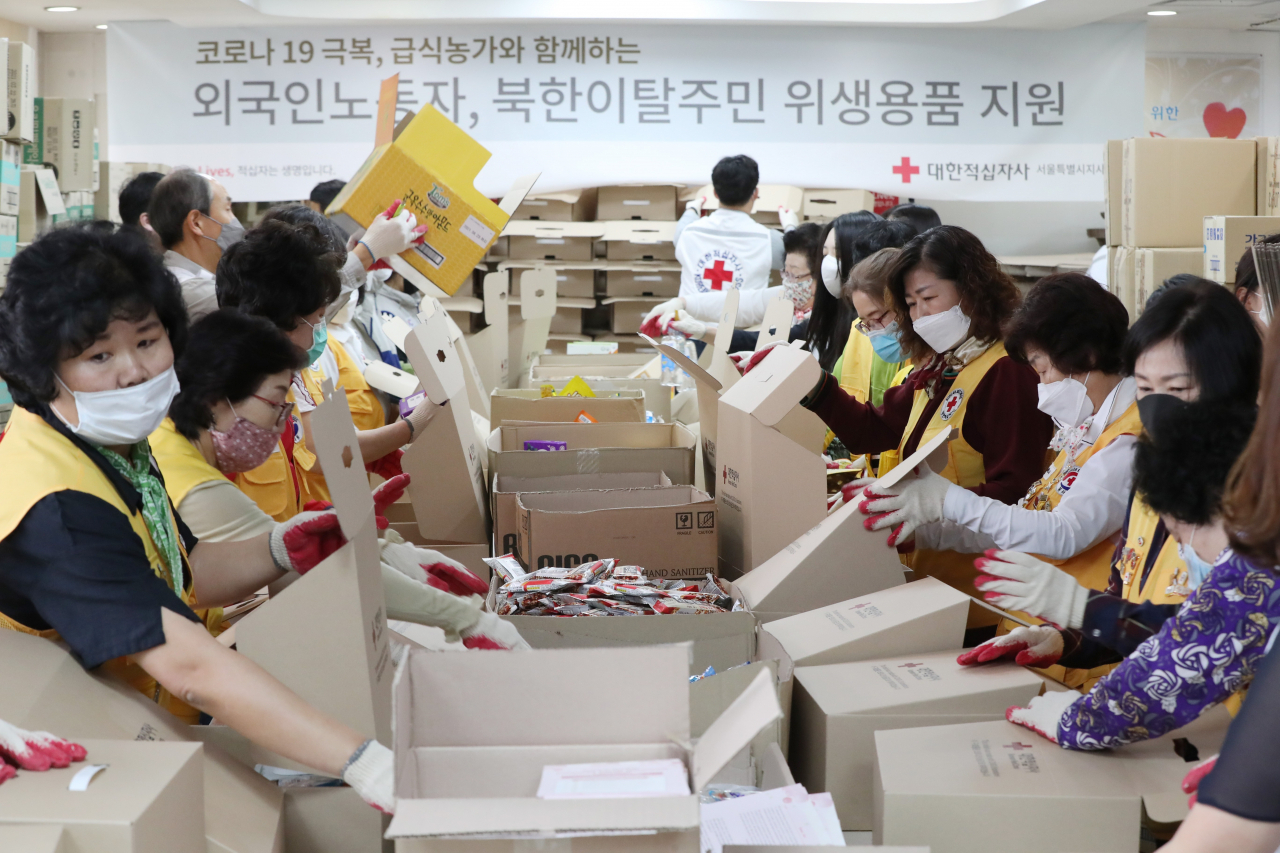 7일 오전 서울 성동구 대한적십자사 서울지사에서 직원들과 봉사원들이 외국인노동자와 북한이탈주민들에게 전달할 코로나19 긴급구호품을 포장하고 있다. 연합뉴스