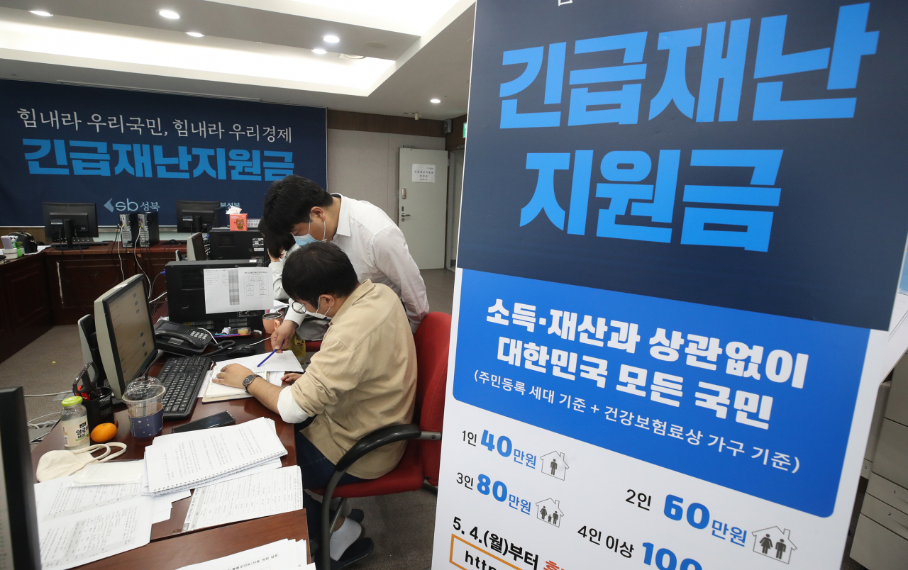 ’코로나19‘ 사태를 극복하기 위한 재난지원금 신청이 지난 11일부터 시작된후 각계에서 자발적 기부 릴레이 기부가 이어지면서 우리나라 기부문화가 한단계 업그레이드 기회를 맞고 있다. 지난 12일 서울 성북구청에서 직원들이 긴급재난지원금 신청과 관련해 안내, 상담을 하고 있다. [연합]　　