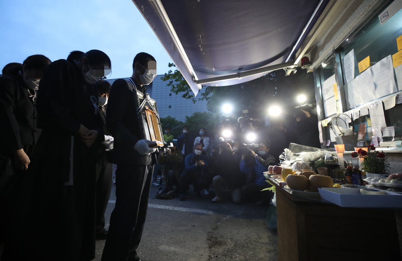 지난 14일 오전 서울 강북구 우이동 한 아파트 경비실 앞에서 아파트 경비원으로 일하다 주민 괴롭힘에 최근 극단적 선택을 한 최희석 경비원의 유족들이 노제를 지내고 있다. [사진=연합뉴스]