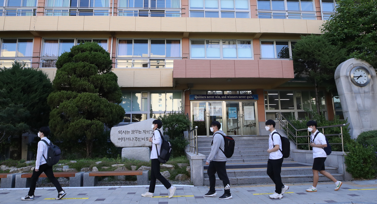 고교 3학년생을 대상으로 한 전국연합학력평가가 실시된 21일 오전 서울 영등포구 여의도고등학교에서 학생들이 서로 간격을 유지한 채 일렬로 안내선을 따라 등교하고 있다. [연합]