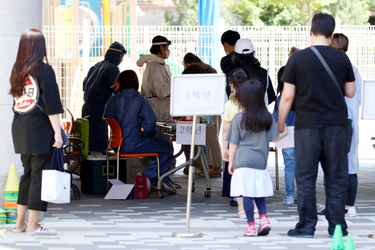 인천지역에 신종 코로나바이러스 감염증(코로나19) 확진자가 속출한 29일 오후 확진자가 발생한 인천시 서구 한 초등학교에 마련된 임시 선별진료소가 시민과 의료진들로 붐비고 있다. [연합]