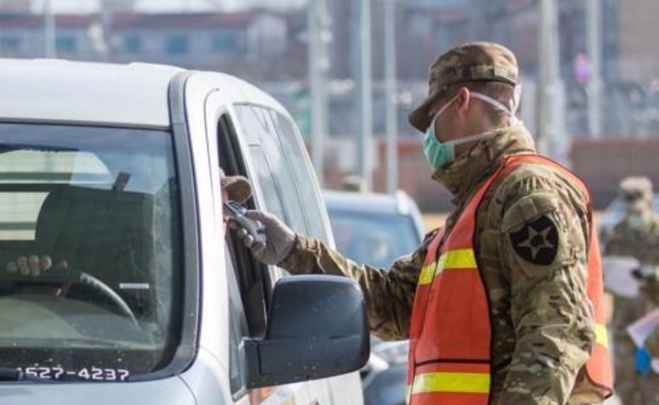 A military guard at U.S. Army Garrison Humphreys in Pyeongtaek, 70 kilometers south of Seoul, checks the temperature of a driver to screen entrants to the compound for the novel coronavirus on Feb. 28, 2020, in this photo provided by United States Forces Korea. (Yonhap)