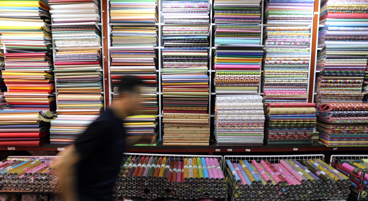 A shopper passes by a paper shop in Namdaemun market in Seoul on Wednesday. (Yonhap)