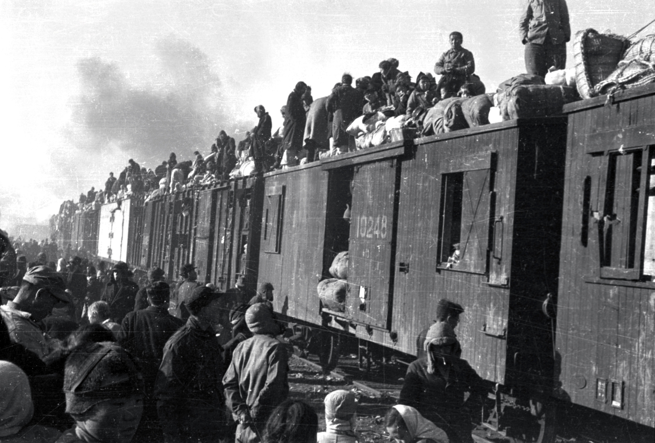 People fleeing the war are shown sitting atop train carriages in a photograph released by the International Red Cross dated December 29, 1950. Yonhap