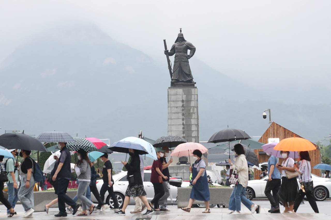 장마가 시작된 24일 오후 우산을 쓴 시민들이 서울 세종대로 사거리를 걷고 있다. [연합]