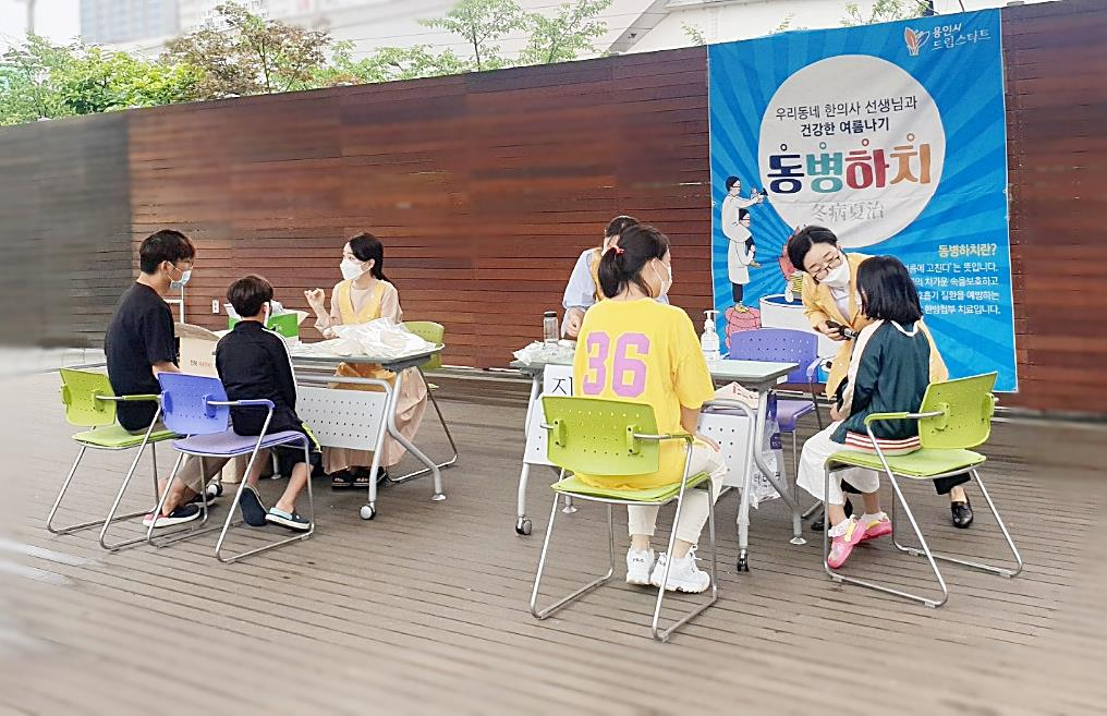 용인시청 야외음악당에서 드림스타트 아동들이 한방진료를 받고있다. [용인시 제공]