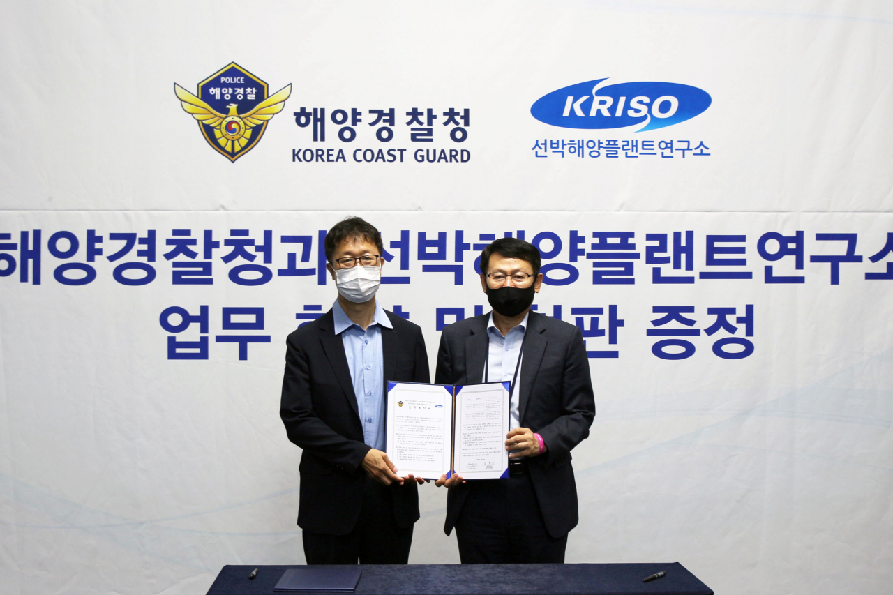 선박해양플랜트연구소 김형우 부소장(왼쪽)과 해양경찰청 정봉훈 경비국장이 부산 벡스코에서 열린 업무협약식 후 기념촬영을 하고 있다.[KRISO 제공]