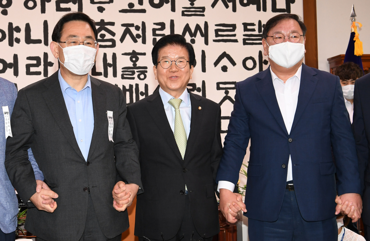 28일 오전 서울 여의도 국회 국회의장실에서 열린 국회의장과 원내대표 정례회동에서 박병석 국회의장과 김태년 더불어민주당 원내대표, 주호영 미래통합당 원내대표가 손을 맞잡고 포즈를 취하고 있다. [연합]
