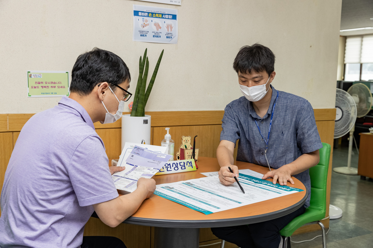 민원인이 부동산중개업 등록 개설등록증과 고지서를 한 번에 발급받고 관련 상담을 받고 있는 모습. [광진구 제공]