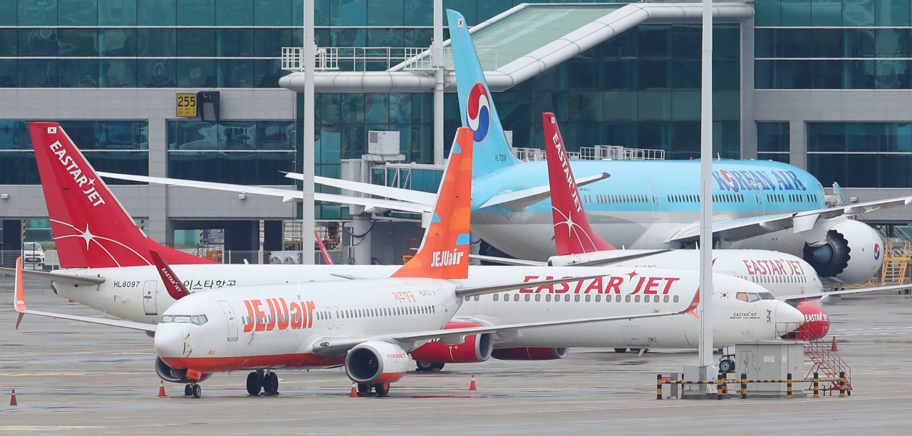 인천국제공항 주기장에 제주항공과 이스타항공 소속 여객기가 각각 세워져 있다. [연합]